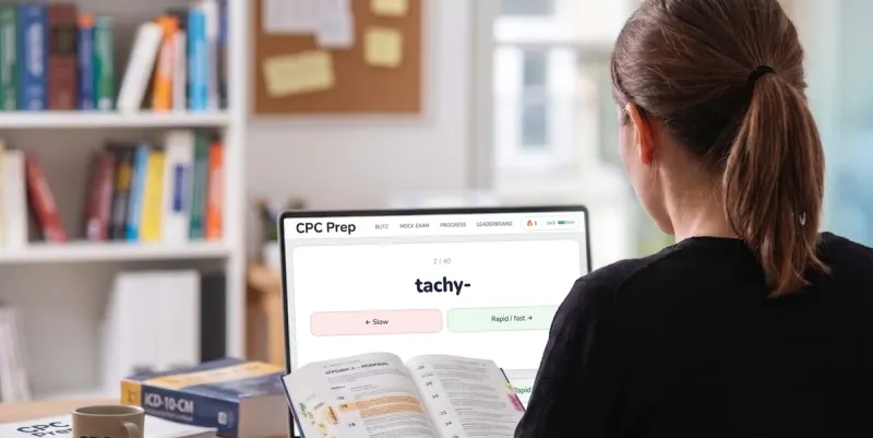 Medical coder reviewing CPT modifier codes at a clinic computer